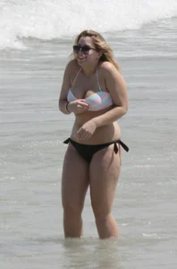 Big boobed thick blonde on the beach in a bikini