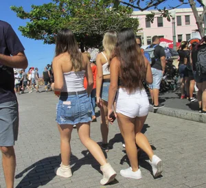 Three sexy friends in denim shorts and a skirt