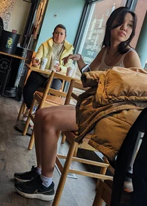 Slender asian teen oblivious at the cafe