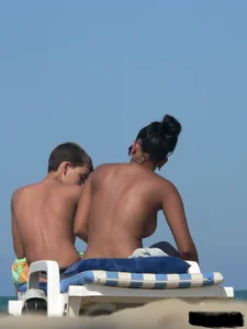 Hot ass topless beach girl with great tits lets her little brother oil up her ass in thong bikini
