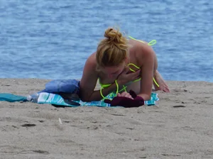 Sexy ass blonde milf on the beach in a thong with cameltoe and bending over
