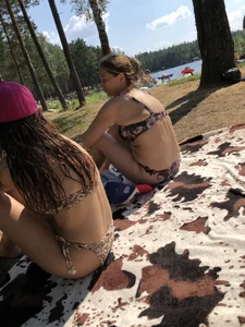 Girls With Wet Hair in Swimsuits Sitting on a Blanket in a Nature Park