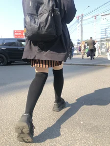 Legs in Knee-Socks And a Skirt - Young Girl Passing By on the Street