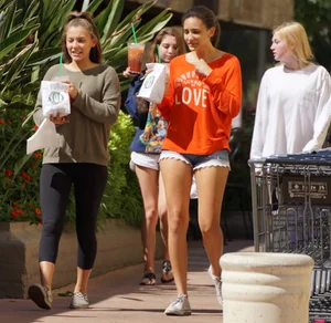 Brunette in tiny shorts walking with her sexy friend in leggings