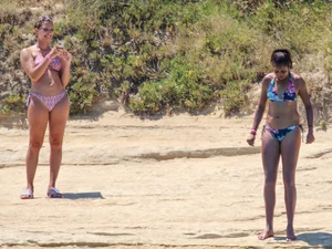 Group of sexy friends at the beach in bikinis