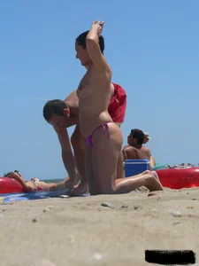 Purple thong topless lady on the beach gets oiled up by her husband
