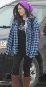 A cute brunette in leggings boots and hat