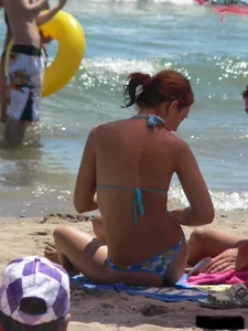 A bunch of hot babes on the beach in thong bikinis