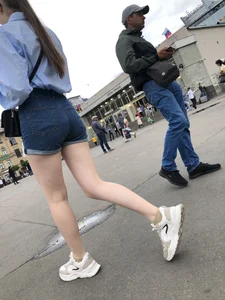 Candid Girl in Blue Denim Shorts and Sneakers Walking Down the Street - Hot Legs Crepshots Collection