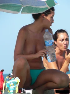 Bunch of sexy babes on the beach topless and in thong bikinis