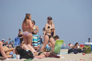 Two thick white girls in bikinis on the beach with big asses