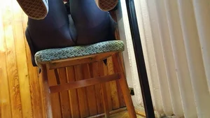 Girl in Black Tights Sitting on Chair With Raised Legs Closeup Creepshot