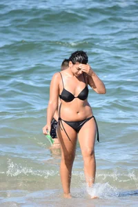 Thick mature brunette bikini lady on the beach with a nice body