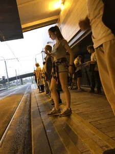 Cute Teen in Shorts on the Tram Stop