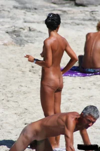 Smoking milf at a nude beach with a hairy pussy