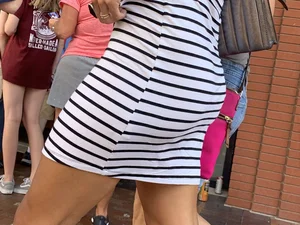 Bunch of girls in various outfits at a Cardinals baseball game