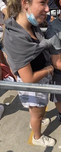 Teen with braces waiting in line for a ride