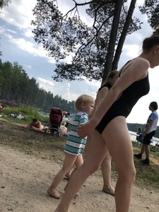 Cute Barefoot Girl in a Black Body Swimsuit Walking on a Road