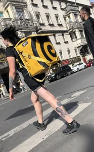 Amazing cute candid food delivery girl with lots of tattoos crossing the street