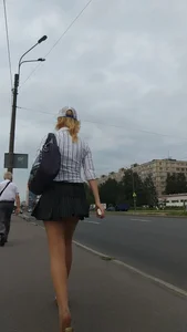 Blonde girl wearing a skirt walking down the street video