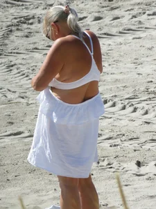Mature blonde lady on a nude beach with big boobs