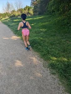 Fit asian chick running in tight pink shorts