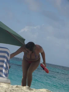 Lady with big tits wearing pink thong on the beach