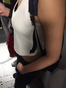 Sexy Asian showing bra under shirt and a little cleavage