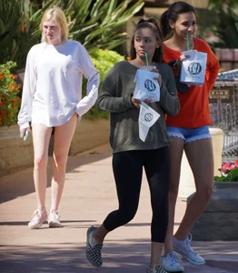 Brunette in tiny shorts walking with her sexy friend in leggings