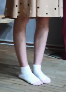 Skinny Legs And Feet in White Socks of a Teen Candid Girl in a Dress
