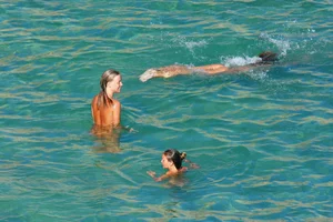 FKK Nudists playing in the water with floater