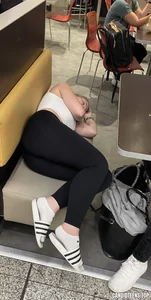 Girl in tighs and slippers asleep in a cafe