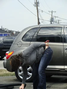 Girl cleaning her car in jeans and showing some cheetah print underwear