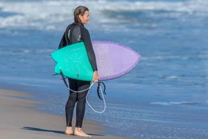 Candid girls surfing on the beach