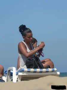 Hot ass topless beach girl with great tits lets her little brother oil up her ass in thong bikini