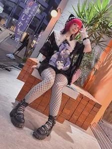 Adorable cosplayer girl wearing fishnet pantyhose