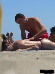 Purple thong topless lady on the beach gets oiled up by her husband