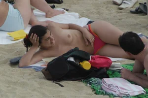 Topless girls on a beach in Barcelona