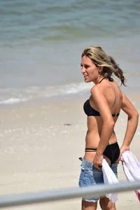 Blonde and brunette on the beach looking sexy in their bikinis