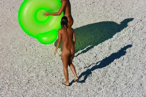 FKK Nudists playing in the water with floater