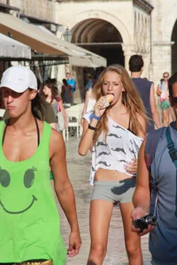 Sexy skinny blonde eating ice cream in short tight grey shorts
