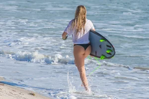 Candid girls surfing on the beach