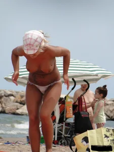 Tattooed blonde with big tits topless and in thong