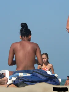 Hot ass topless beach girl with great tits lets her little brother oil up her ass in thong bikini