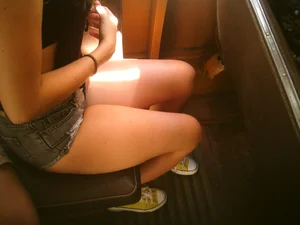 Sexy girl on the bus in jean shorts with nice legs and cleavage
