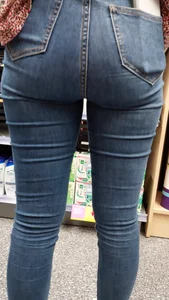Brunette girl with nice ass sexy PAWG in tight jeans in a store