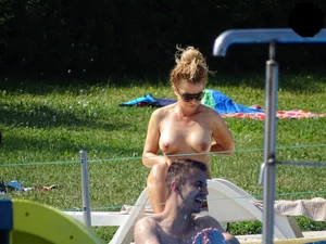 Topless lady at the pool with nice tits
