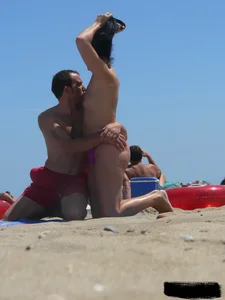 Purple thong topless lady on the beach gets oiled up by her husband