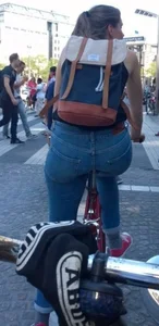 Blonde girl on a bike with a big tight ass in tight jeans
