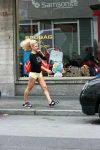 Blonde looking sexy walking in short yellow shorts